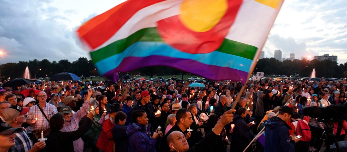 DENVER, CO - JUNE 13: Mark Wonder waves his rainbow color Colorado flag as he and about 2,000 supporters attended the PFLAG Denver chapter candle vigil June 13, 2016 at Cheeseman Park. A silent candle vigil was held in support of the tragic event at Pulse Night Club in Orlando, Florida.  (Photo By John Leyba/The Denver Post)